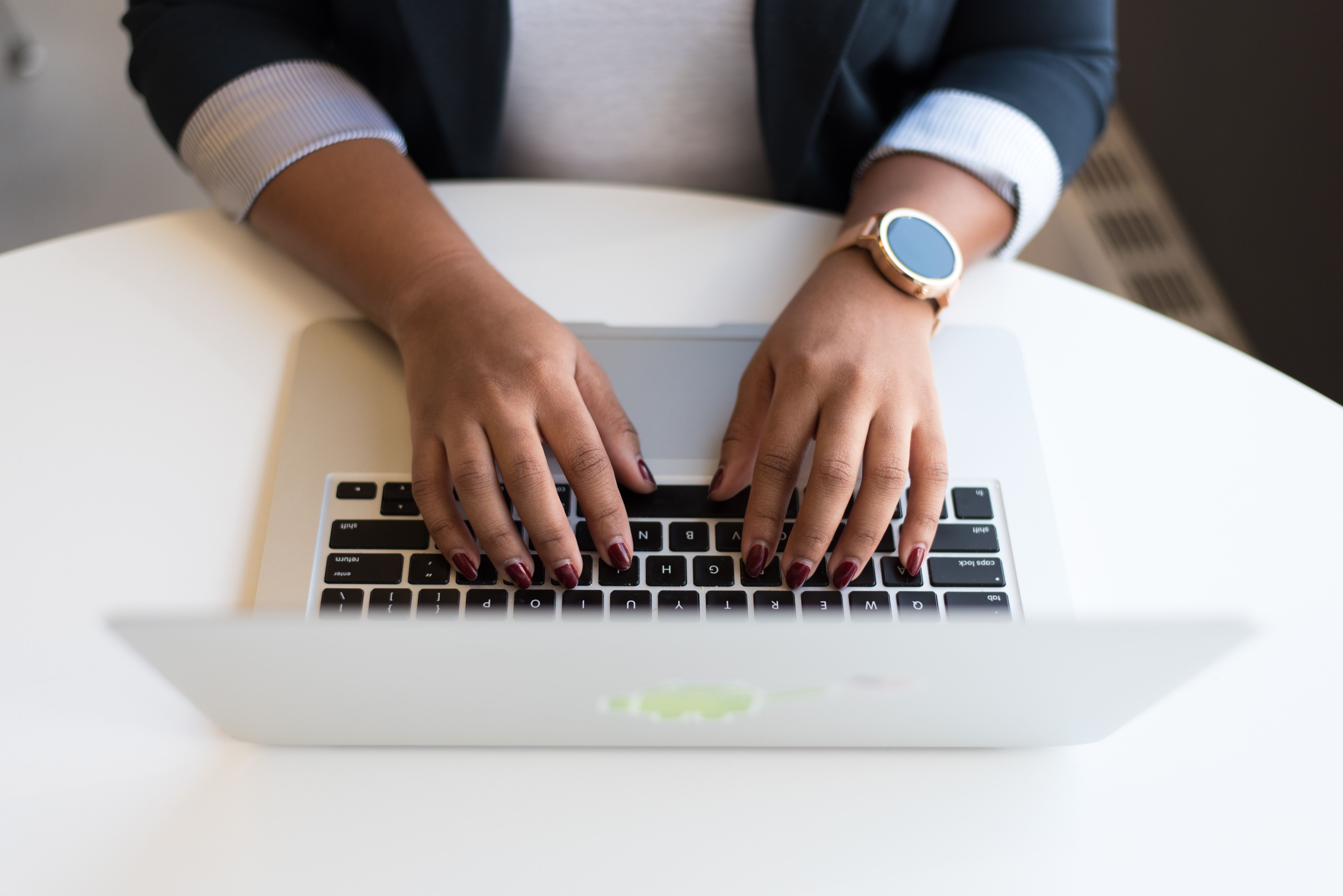 hands typing on laptop keyboard