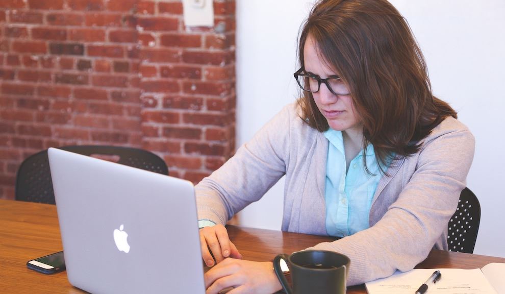 Woman frustratedly staring at her laptop